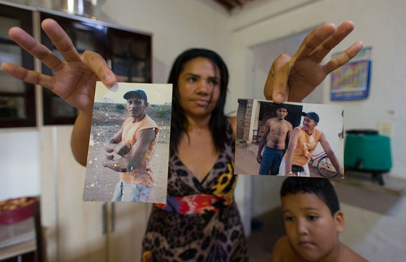 TOXIC TOLL: Gerlene Santos holds photos of her late husband, Vanderlei Matos da Silva (left), who died after exposure to pesticides in his job at a pineapple plantation run by Fresh Del Monte. A court recently upheld a $110,000 award in her favor over his death. REUTERS/Davi Pinheiro